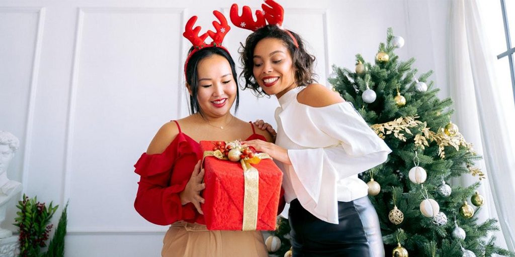 two women with a Christmas gift how to manage holiday-related stress and depression