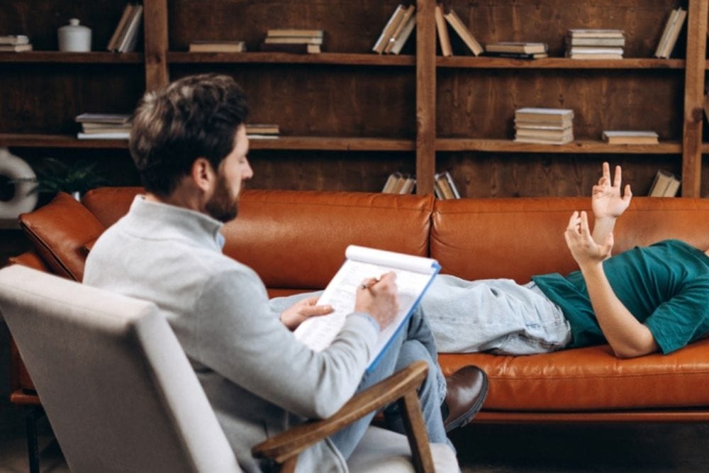 Therapist and patient reviewing a CBT thought record in Fort Lauderdale
